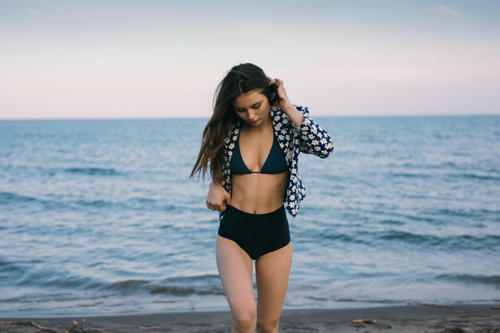 woman wearing black bikini on the seashore