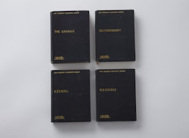 four assorted-title books on white surface
