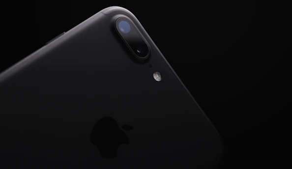 Close-up of a sleek, modern smartphone with vibrant display on a dark tech-themed background