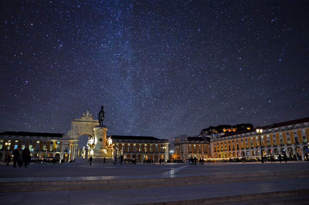 concrete monument surrounded by buildings during nighttime