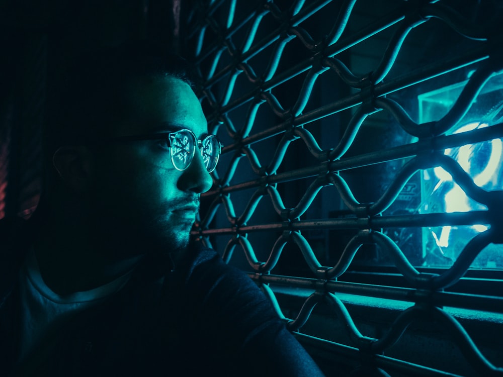 woman wearing eyeglasses while looking on window