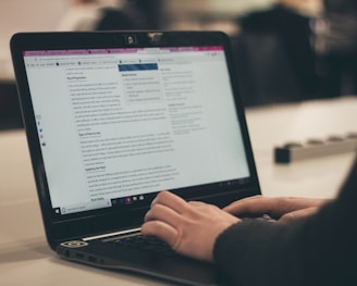 person typing legal news on computer