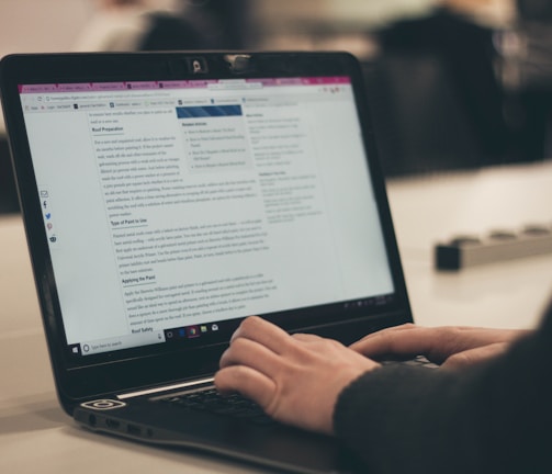 person typing on laptop computer