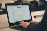 person typing on laptop computer