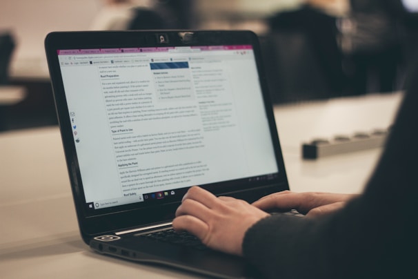 person typing legal news on computer