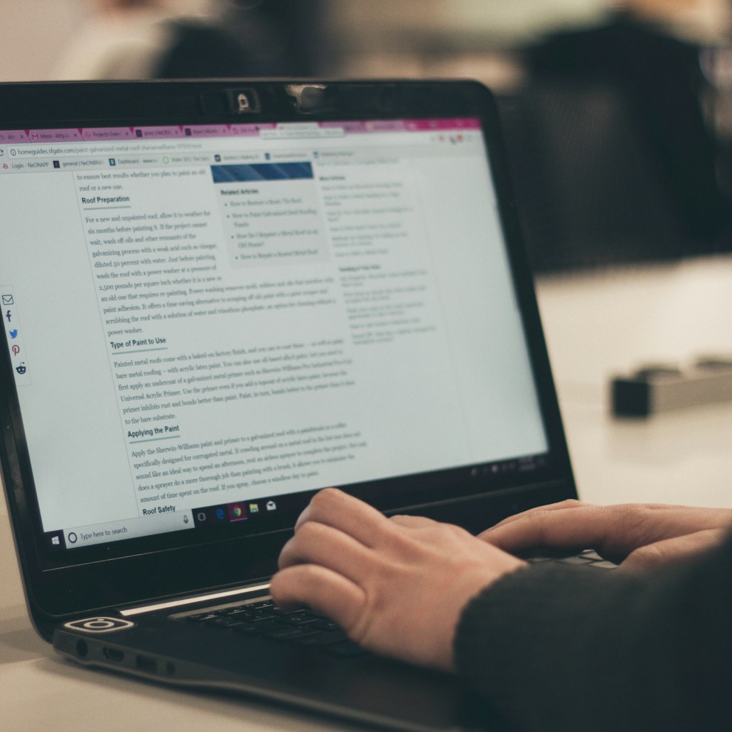 person typing on laptop computer