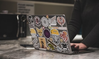 person surfing black laptop near microwave oven