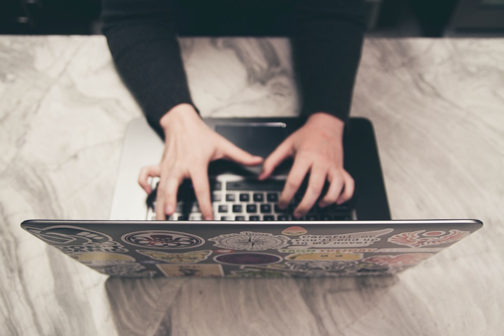 person typing on MacBook