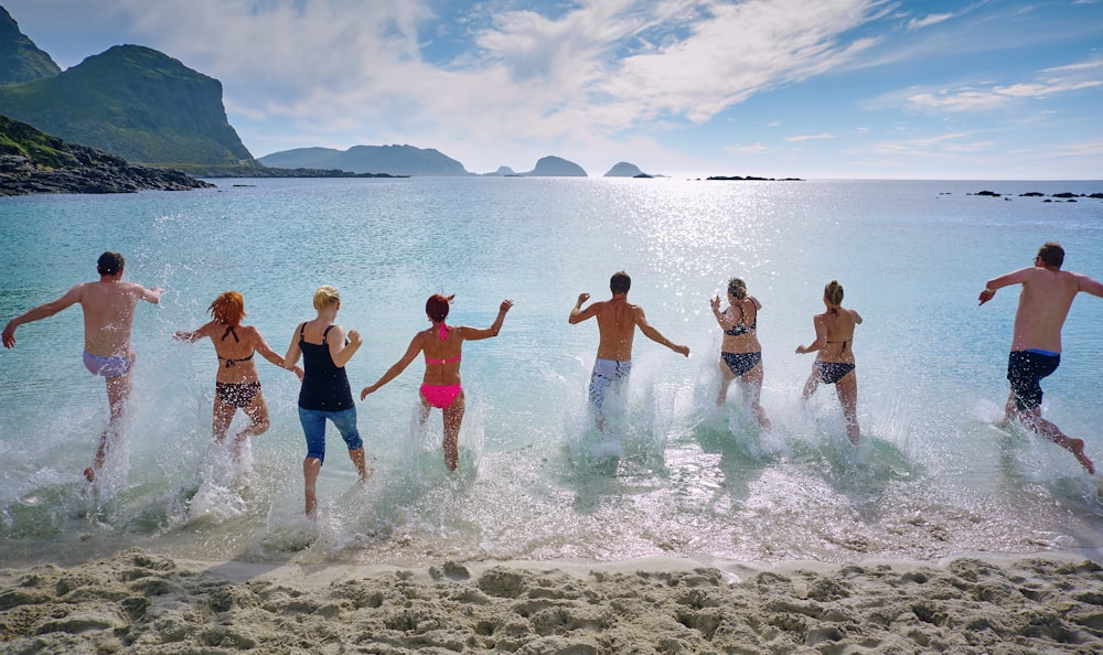 group of people playing on beach