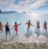 group of people playing on beach