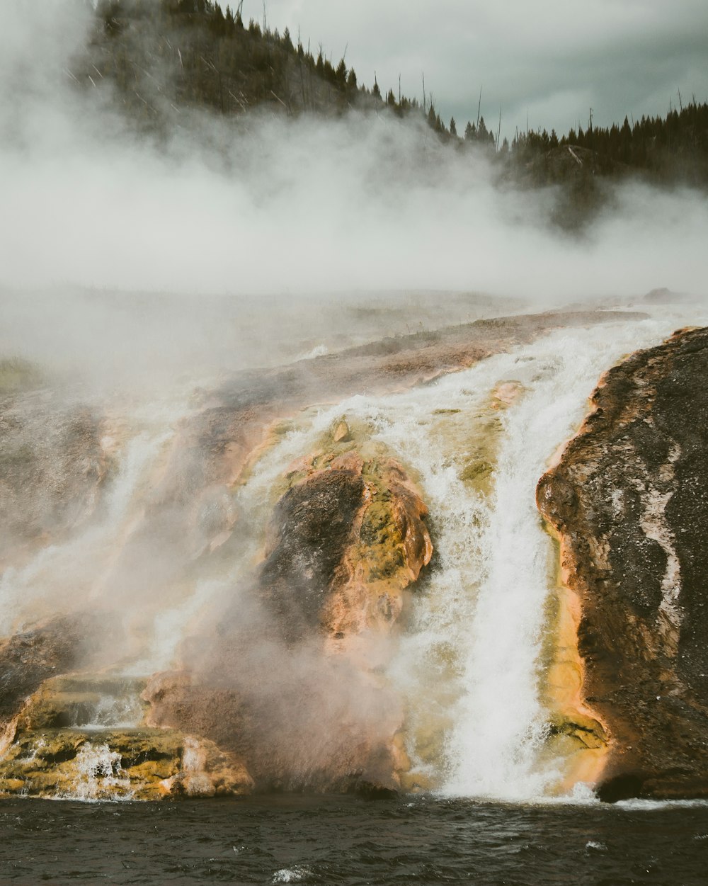 waterfalls in mountain at daytime