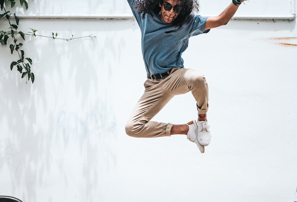 man jump on front of wall