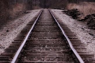 A panoramic view of a railway track stretching through the Australian outback, highlighting the work environment.