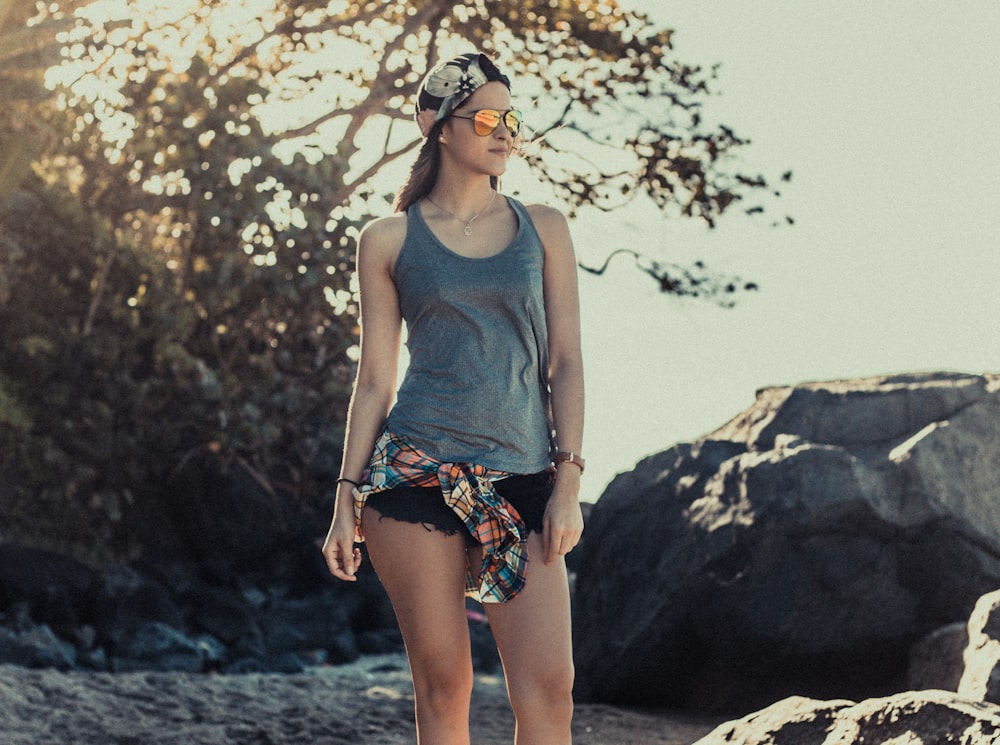 woman standing on sand during daytime