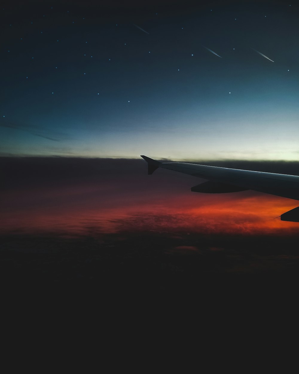 a view of the wing of an airplane at night