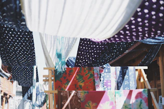 A vibrant display of Jaipuri cotton kurtis hanging gracefully in a sunlit boutique.