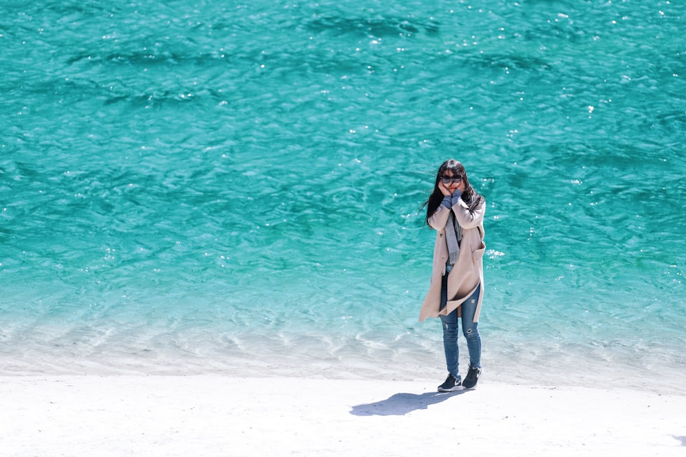 woman standing near seashore during daytime