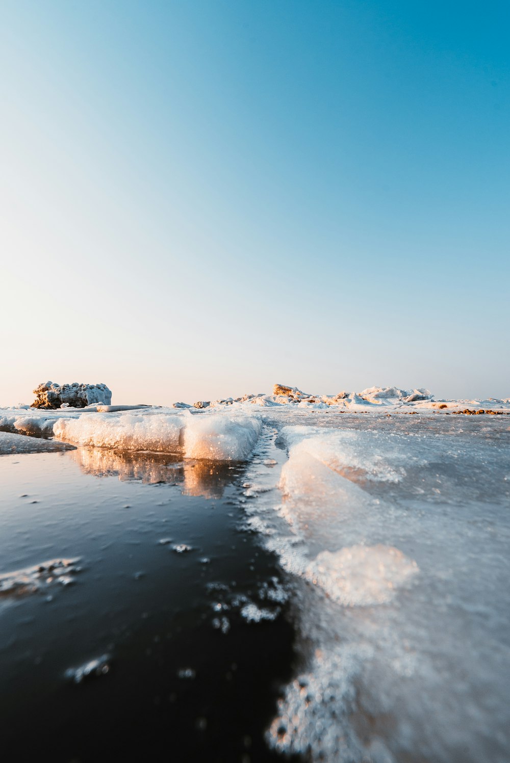 ice on water near stones