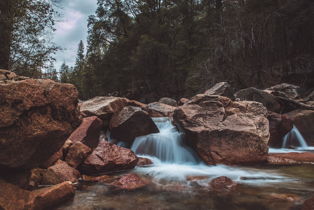 water flowing on brown rocks