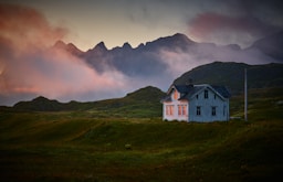 white and gray house near mountain under cloud