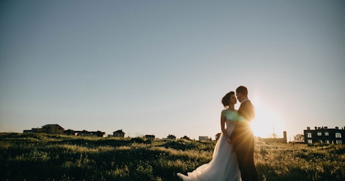 bride and groom on green grass field