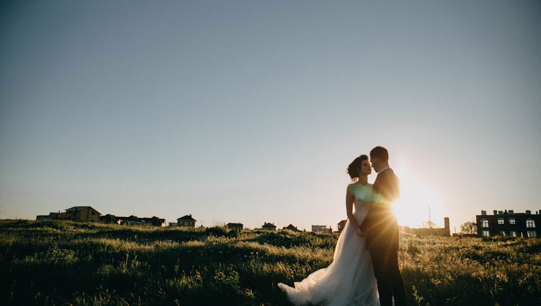 bride and groom on green grass field