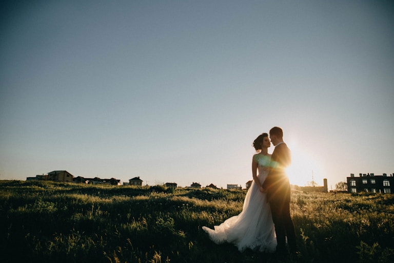 bride and groom on green grass field