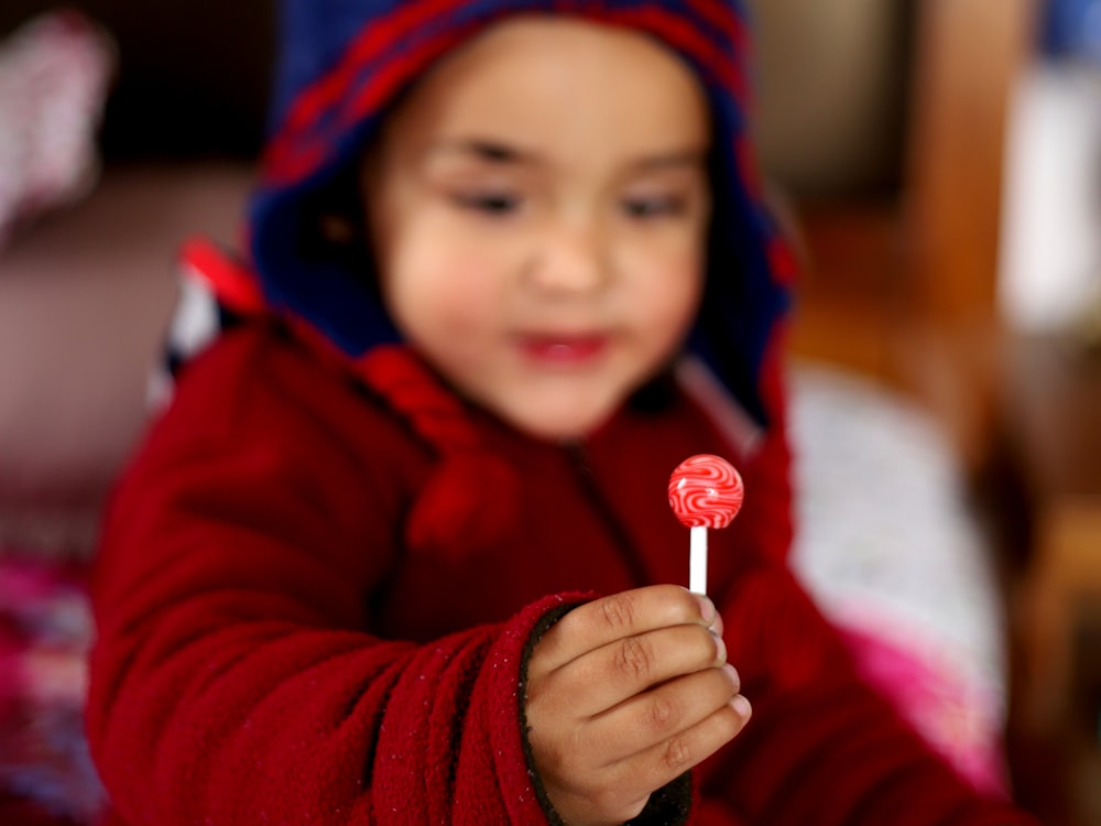 baby holding lollipop