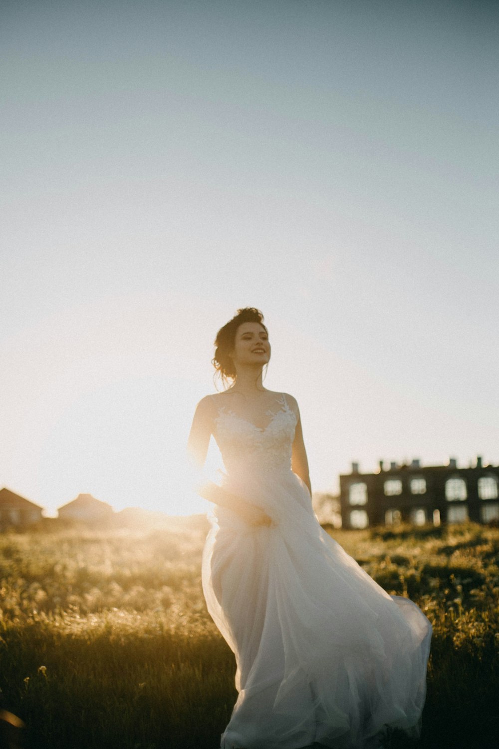 woman in white spaghetti strap dress smiling during daytime