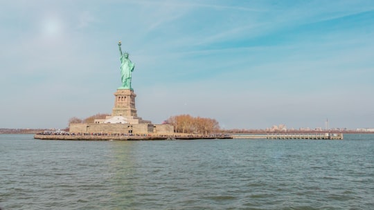 Statue Of Liberty on island surrounded by water in Statue of Liberty United States