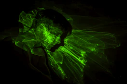 Dynamic shot of a person training intensely with neon green light trails symbolizing AI energy.