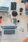 people sitting down near table with assorted laptop computers