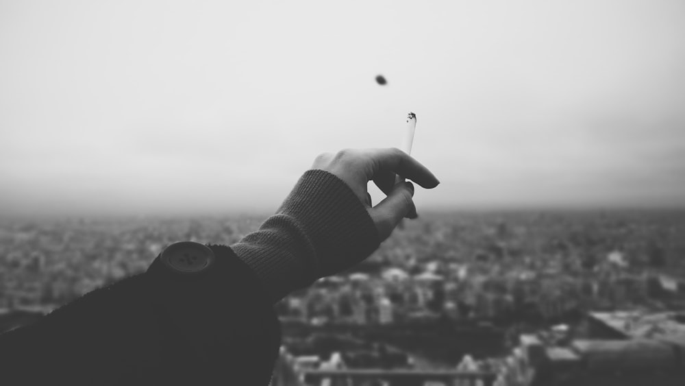 person holding cigarette stick