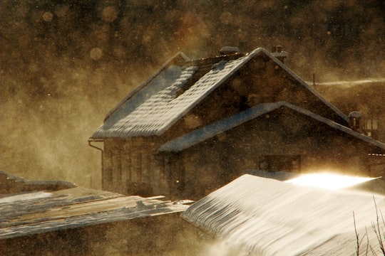 snow-coated brown house painting in Radovljica Slovenia