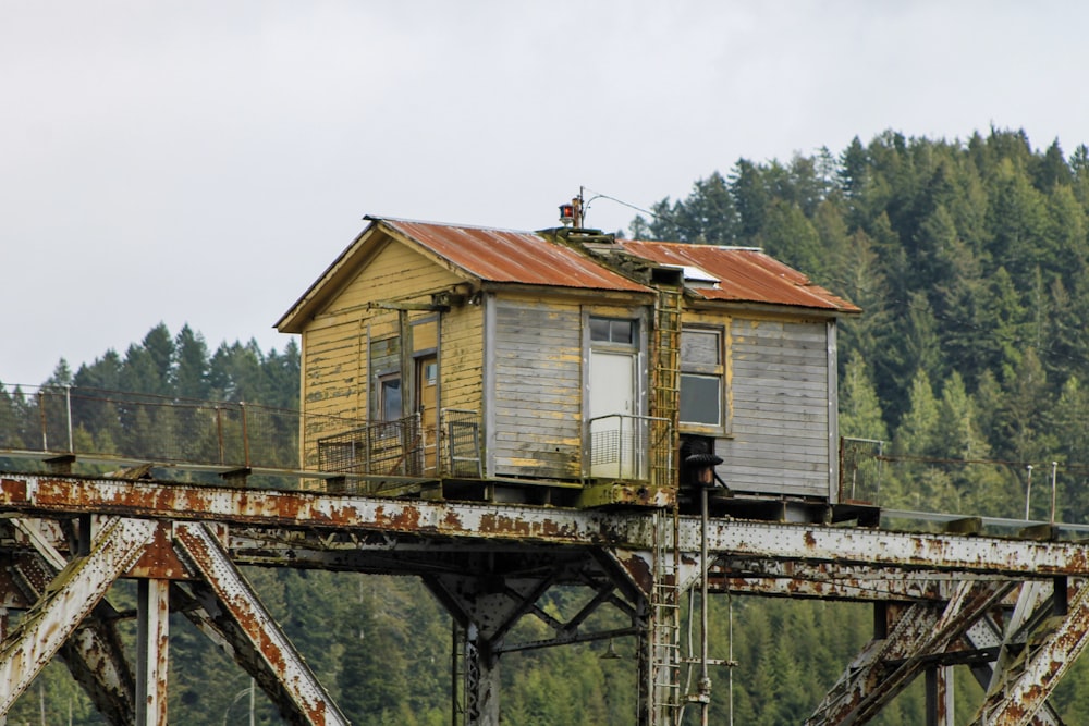 yellow and brown wooden house on rusted steel beams