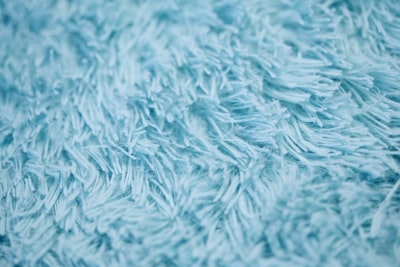 closeup photography of blue textile tactile zoom background