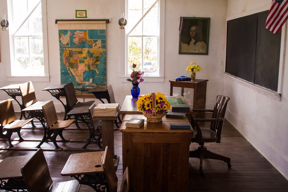 vacant white painted classroom with chairs, tables , and map on the wall