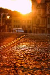 Warm sunset view of San Miguel de Allende's cobblestone streets with colonial architecture and golden light.