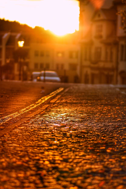 Warm sunset view of San Miguel de Allende's cobblestone streets with colonial architecture and golden light.