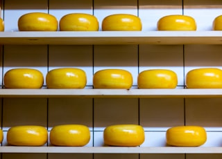 yellow cheese lot on brown wooden shelf