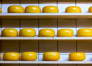 yellow cheese lot on brown wooden shelf