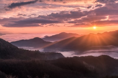 overlooking view of mountains and sunrise evening teams background