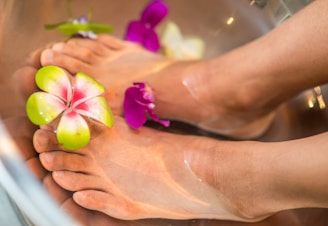 person's feet with flowers