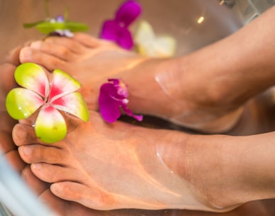 person's feet with flowers