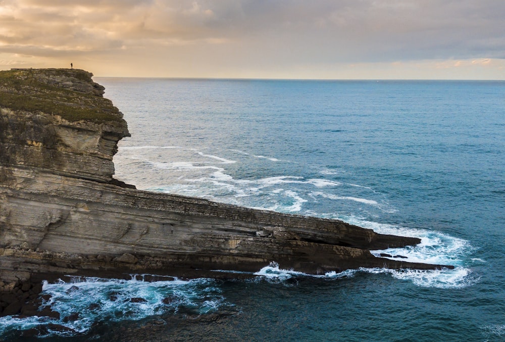 rock monolith beside seashore