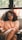 woman sitting on chair leaning on window
