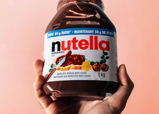 person holding Nutella jar