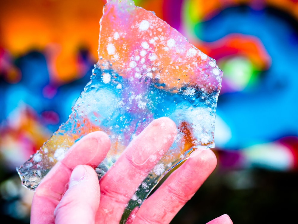 selective focus photography of person holding melted ice