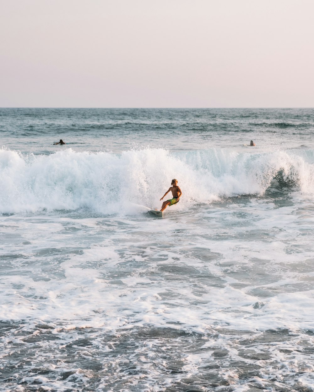 man surfing on sea during daytime