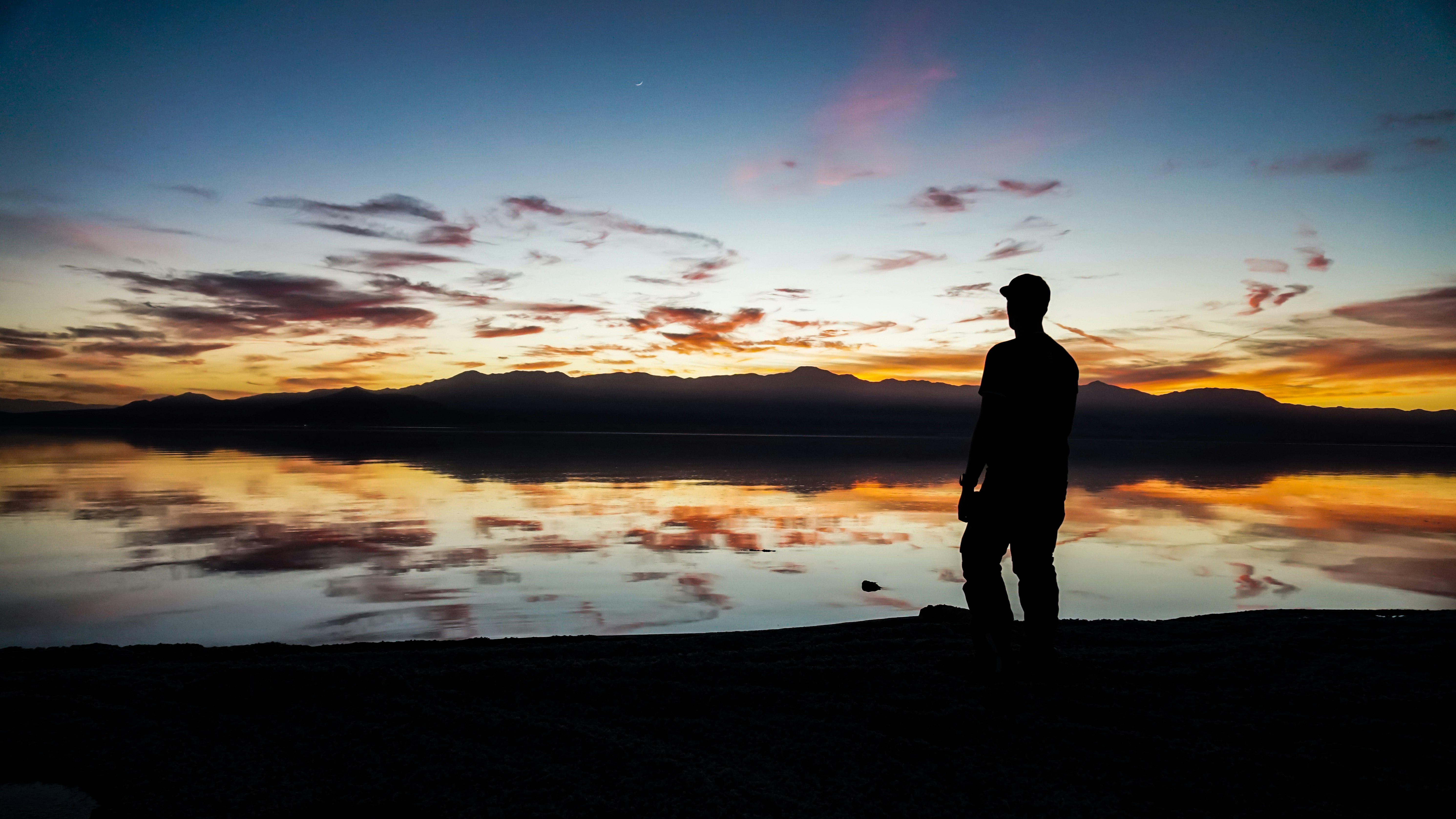 silhouette of man standing on sand